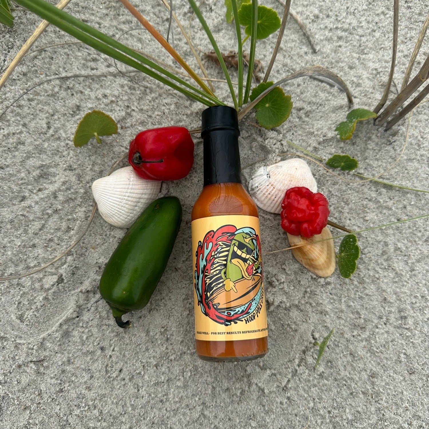 A bottle of Apple Peach Hot Sauce, blending the sweet, fruity flavors of apple and peach with a mild heat, perfect for adding a sweet and spicy twist to your favorite foods.