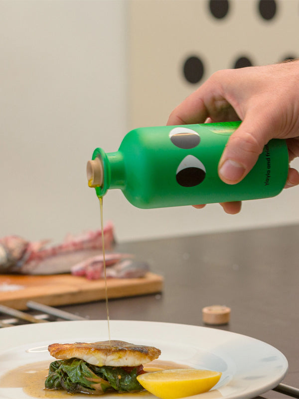 A bottle of Yiayia & Friends Extra Virgin Olive Oil infused with basil, offering a fragrant and fresh herbal flavor, perfect for enhancing salads, pasta dishes, and more.
