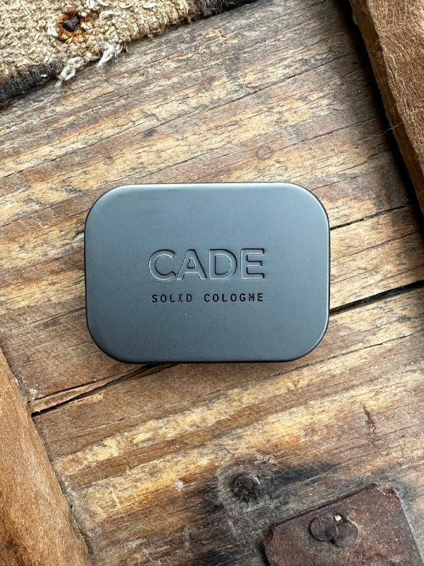 Solid cologne in Cade, featuring a rugged, smoky aroma with woody and herbal notes, perfect for a subtle and long-lasting scent on the go.