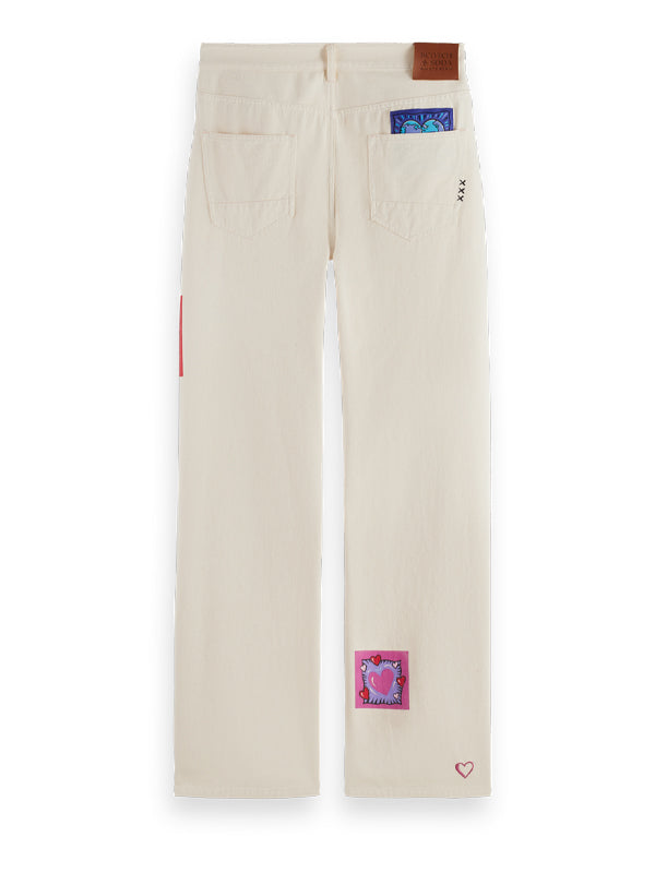 Burton Morris Straight Leg Jeans: Ecru Love – A timeless denim silhouette featuring a soft ecru wash with artistic flair.