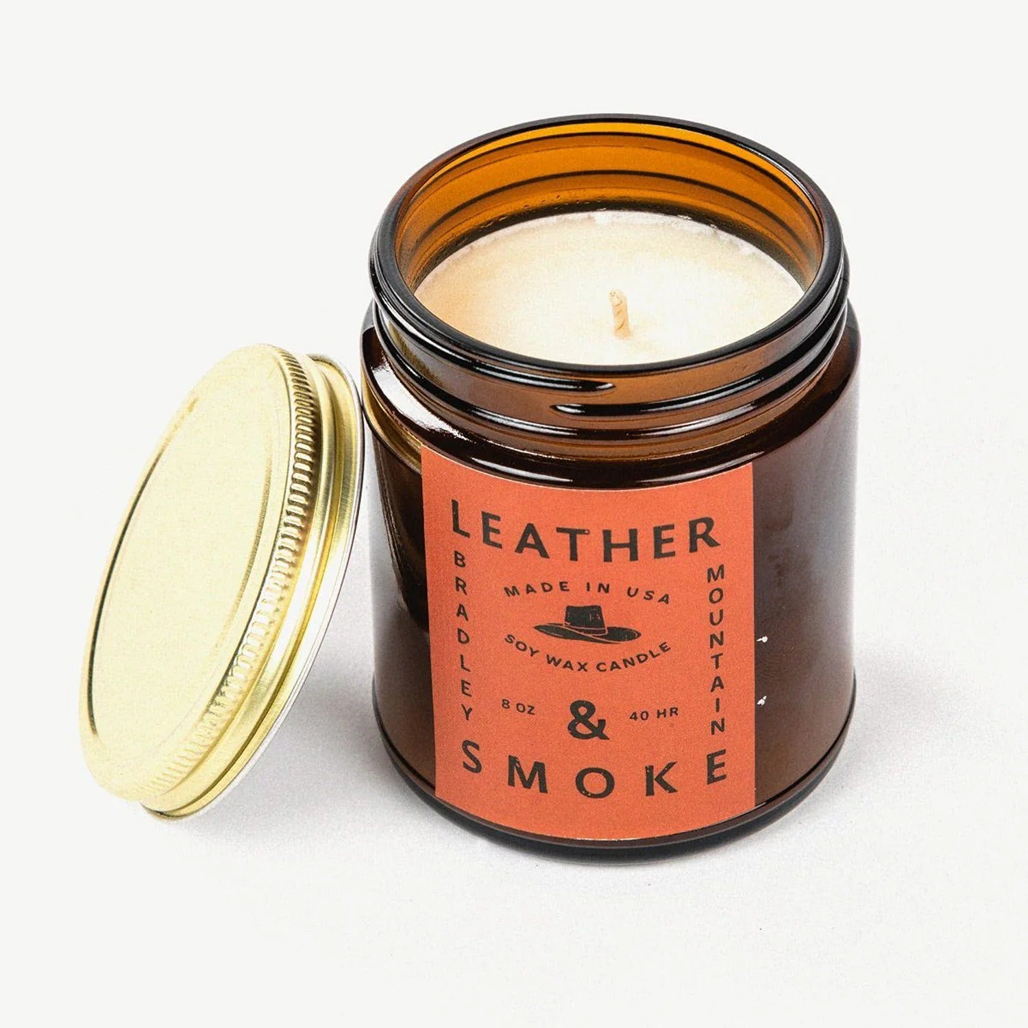 A 7 oz. Leather & Smoke candle, offering a rich, smoky fragrance with earthy leather notes, perfect for creating a cozy, warm ambiance in any room.