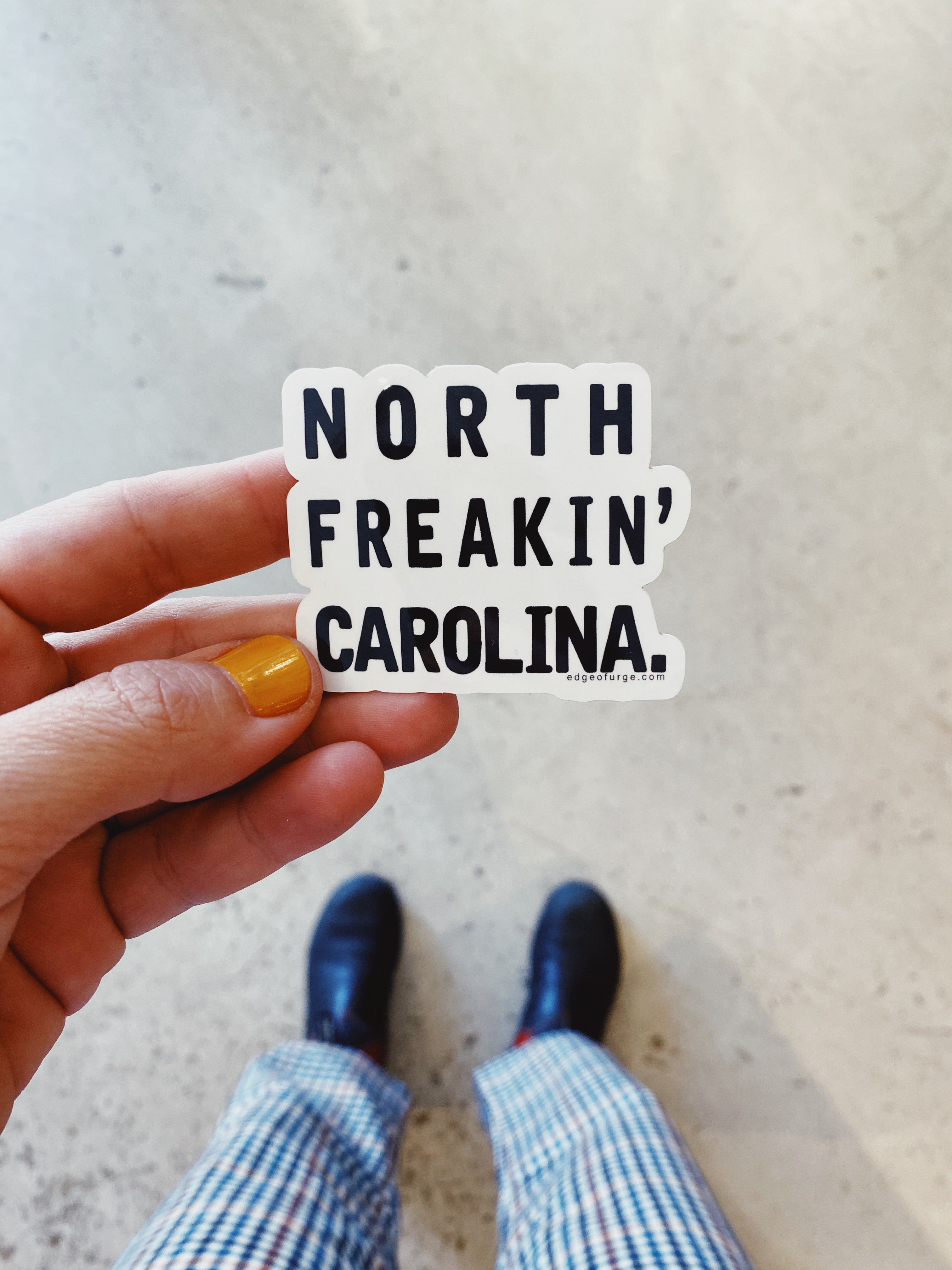 A bold "North Freakin' Carolina" sticker, featuring vibrant text and a fun, playful design, perfect for showing off state pride with a touch of humor.