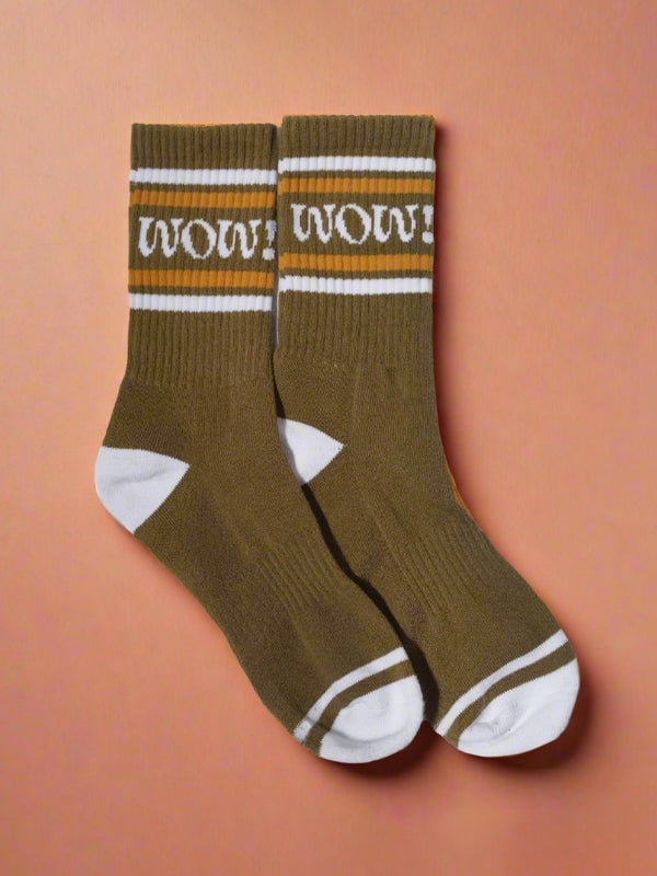 Pair of olive-green socks with the word 'Wow!' embroidered in bold, stylish lettering.