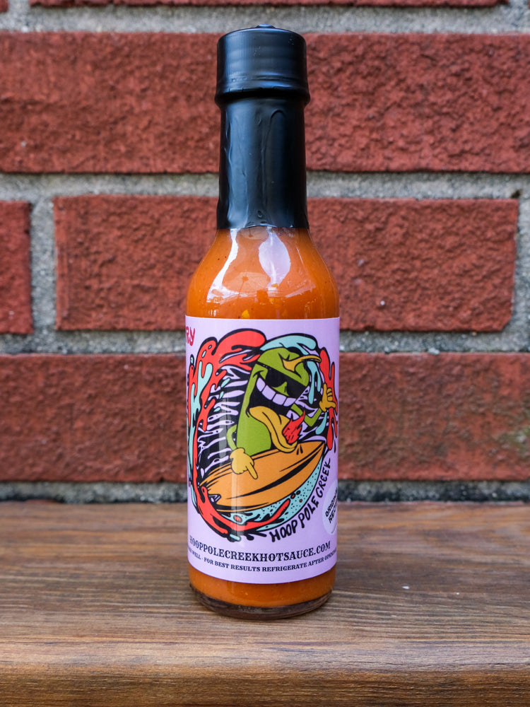 A bottle of Raspberry Reaper hot sauce with a vibrant red label featuring a fiery pepper graphic, indicating its spicy heat level. The sauce inside is a rich, dark red color, suggesting a fruity yet intense flavor profile.