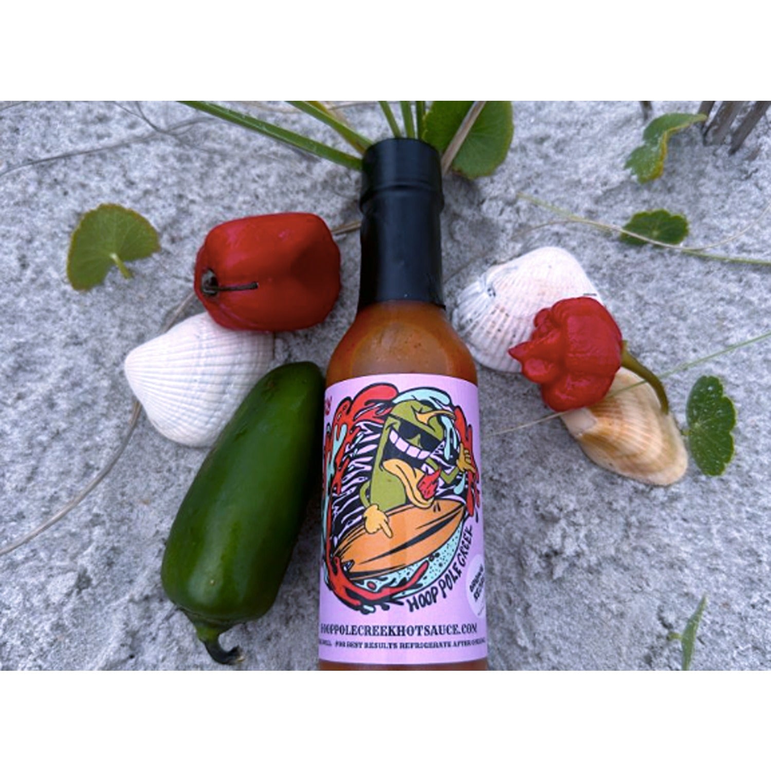 A bottle of Raspberry Reaper hot sauce with a vibrant red label featuring a fiery pepper graphic, indicating its spicy heat level. The sauce inside is a rich, dark red color, suggesting a fruity yet intense flavor profile.