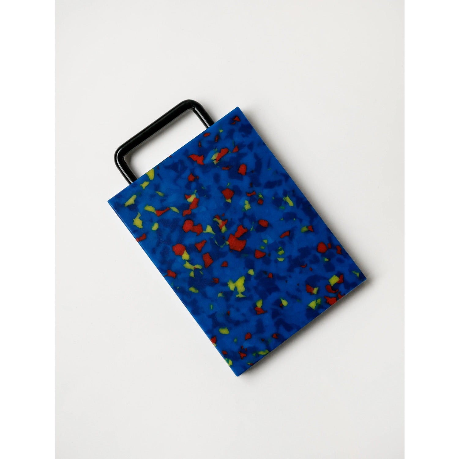 A small blue cutting board with a handle, designed for easy handling and compact storage.