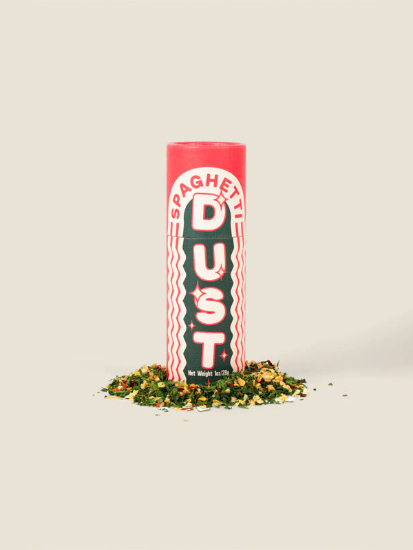 A jar of Spaghetti Dust, a flavorful seasoning blend designed to add a burst of savory spices to your pasta dishes, enhancing the taste of spaghetti or any favorite Italian meal.