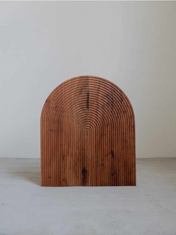 Wooden bread board with an arched groove design, ideal for slicing and serving bread with style.