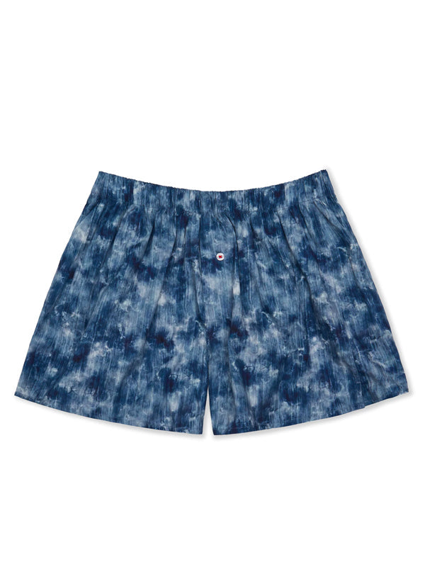 Organic cotton boxer shorts in Shibori Clouds Indigo, featuring a unique tie-dye pattern in deep blue and white hues.