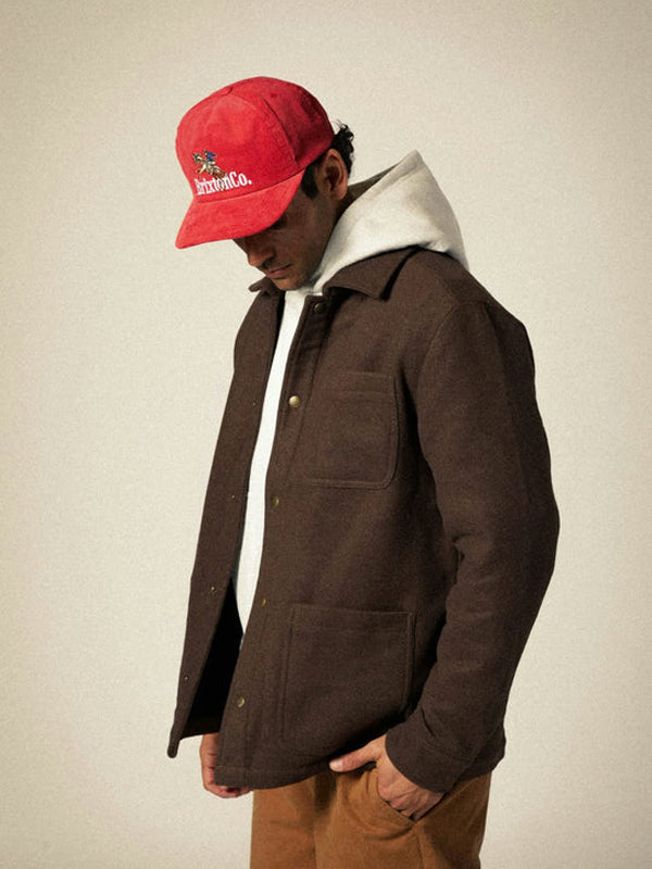 A red Brixton Inwood Snapback hat featuring a classic design with a structured fit and adjustable strap, offering a stylish and casual look for any outfit.
