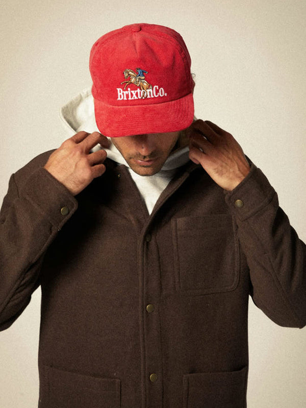 A red Brixton Inwood Snapback hat featuring a classic design with a structured fit and adjustable strap, offering a stylish and casual look for any outfit.