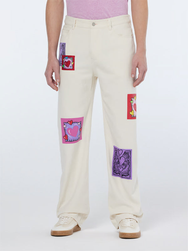 Burton Morris Straight Leg Jeans: Ecru Love – A timeless denim silhouette featuring a soft ecru wash with artistic flair.