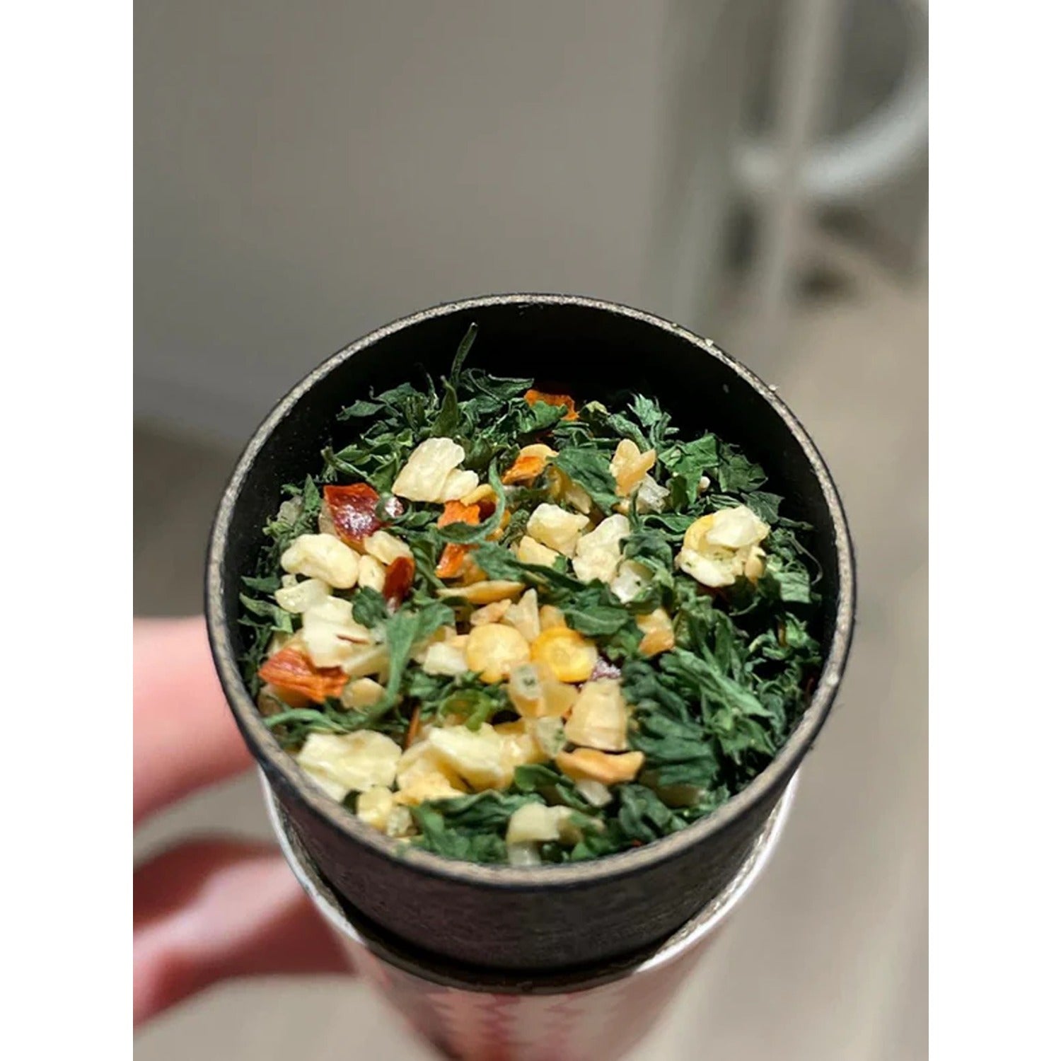 A jar of Spaghetti Dust, a flavorful seasoning blend designed to add a burst of savory spices to your pasta dishes, enhancing the taste of spaghetti or any favorite Italian meal.