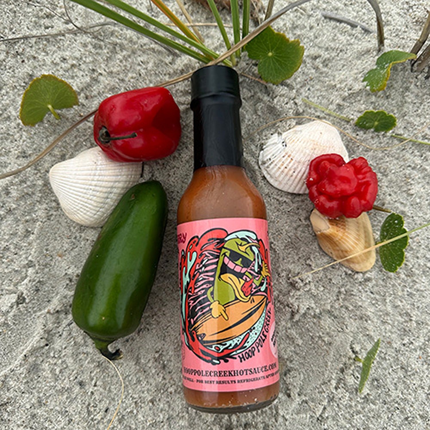 A bottle of Strawberry Spice Hot Sauce, combining the sweetness of ripe strawberries with a spicy kick, perfect for adding a unique, flavorful heat to your dishes.