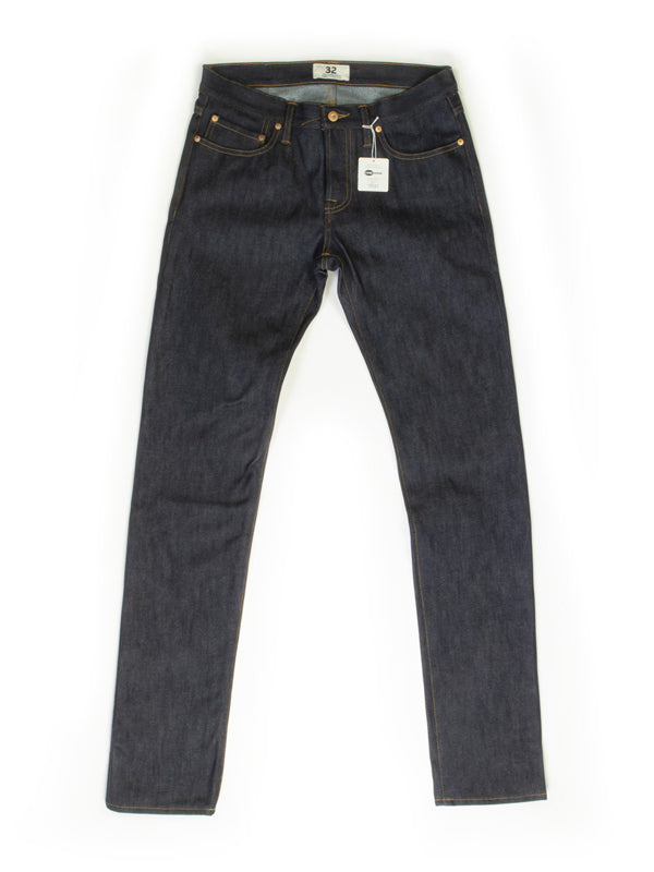 A pair of slim tapered jeans in a classic denim wash, featuring a sleek, fitted silhouette that narrows at the ankle, designed for a modern, stylish fit.